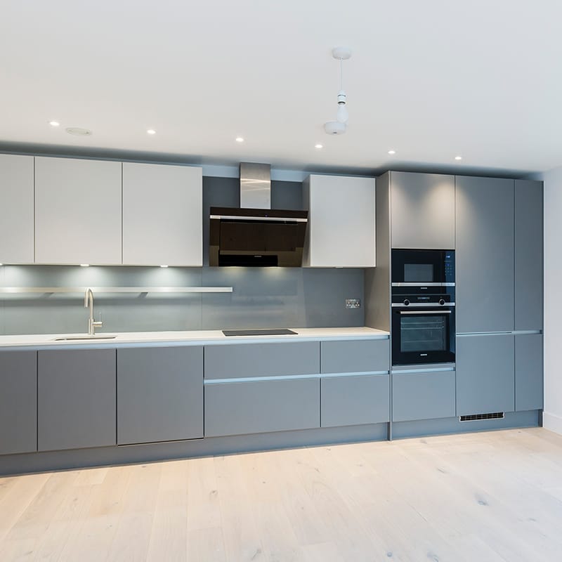 Sleek grey designer kitchen fitting by Hubble